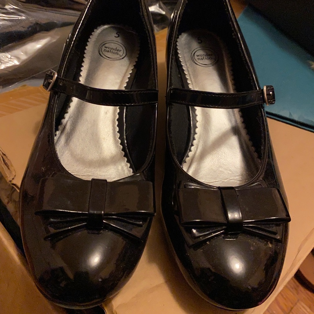 Girls black shoes with a little bit of wedge heel